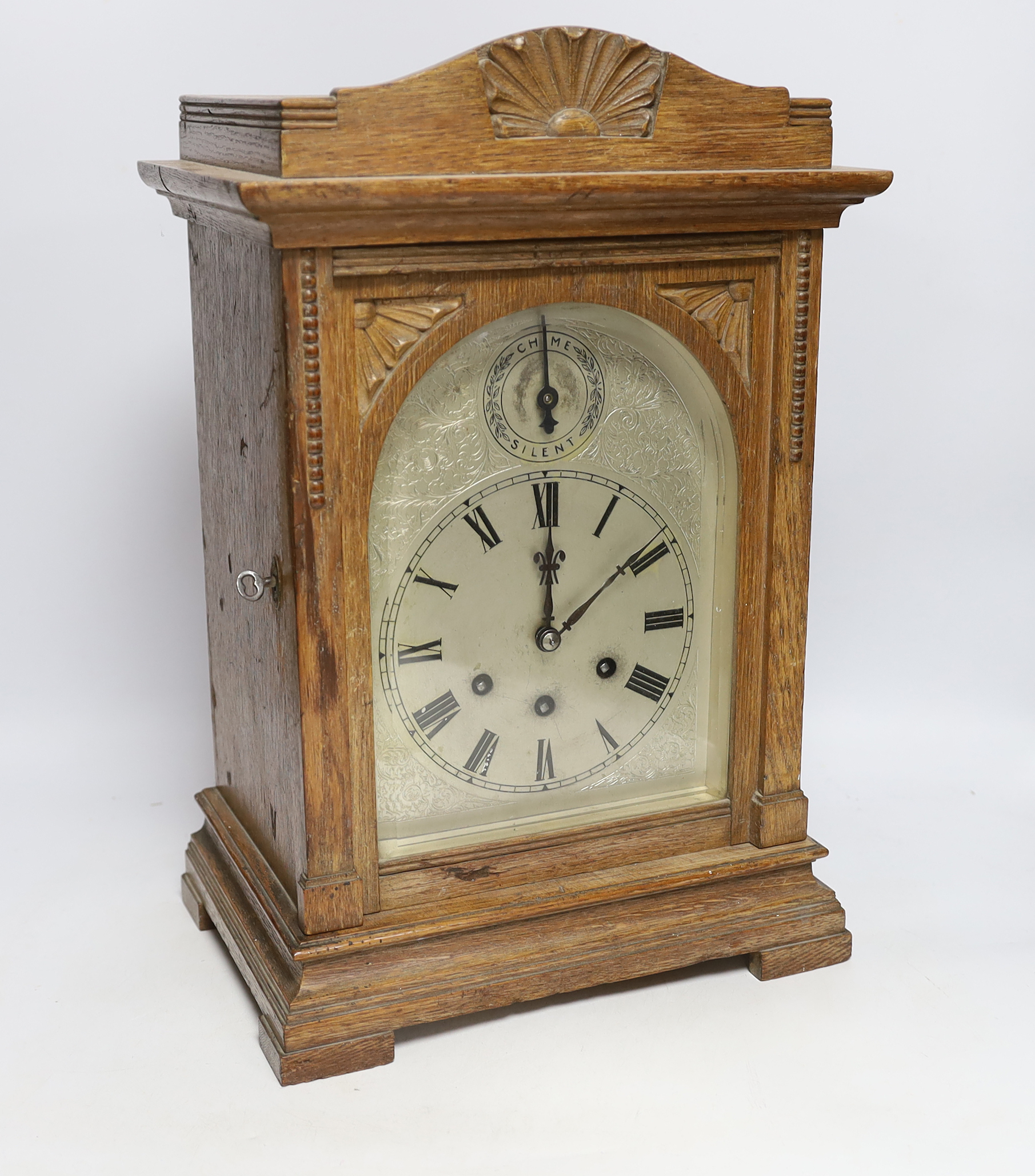 A 1920's Gustav Becker oak bracket clock with three train movement, striking and chiming on five gongs, 42.5cm high